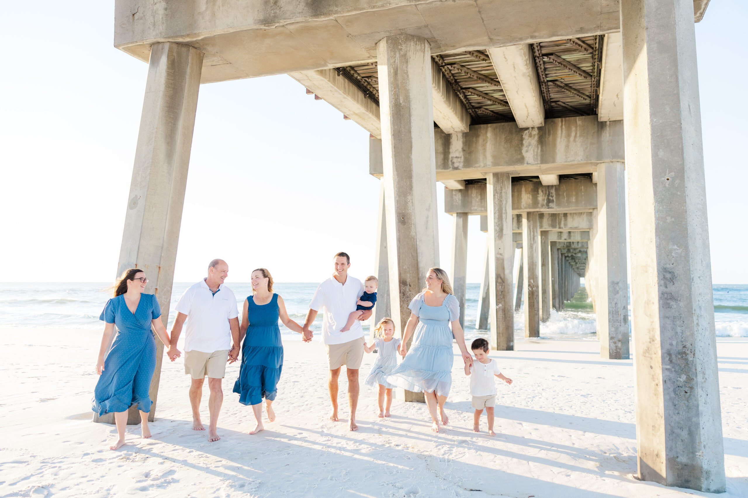 family wearing blues at photoshoot on the beach