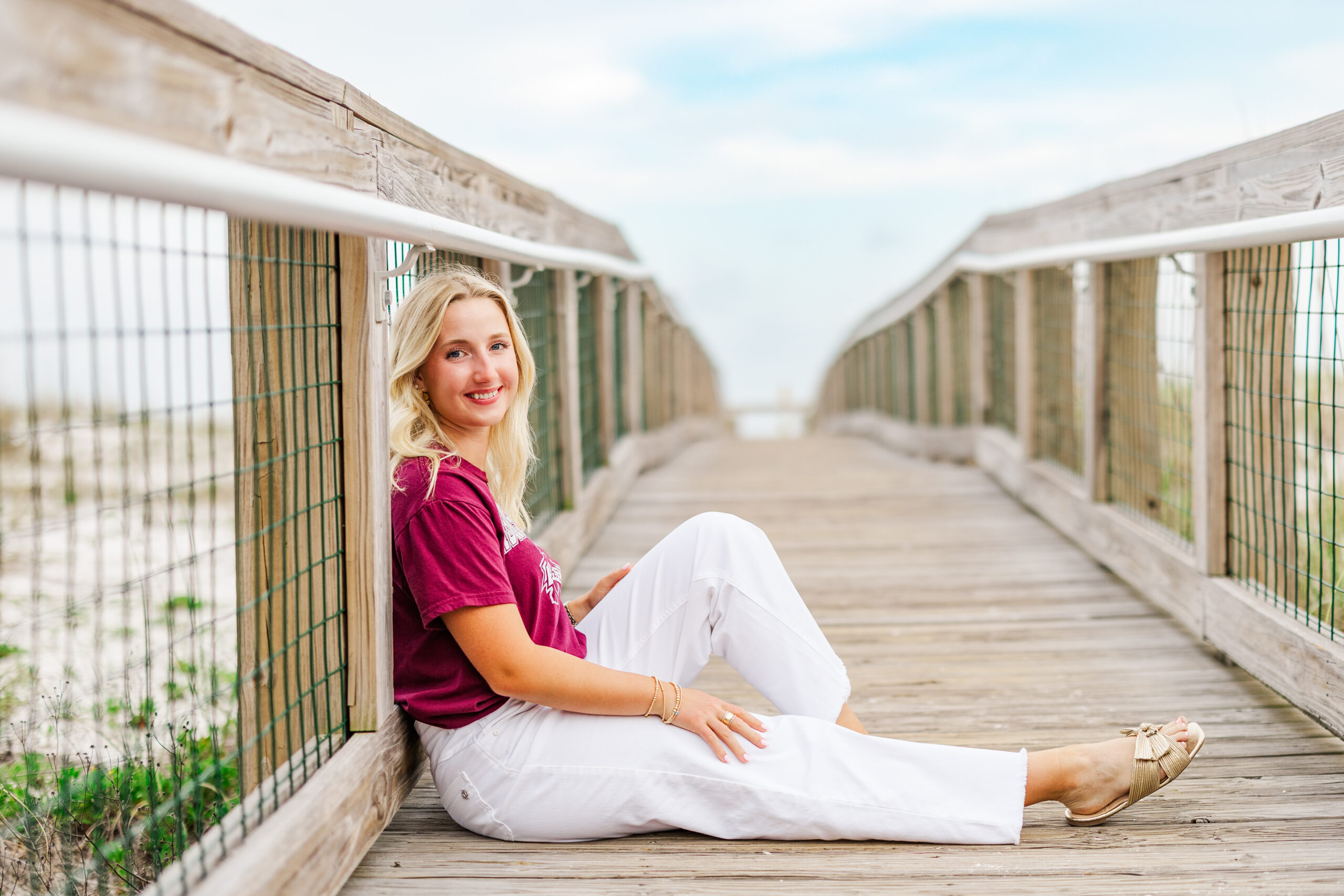 senior photo on boardwalk on pensacola beach